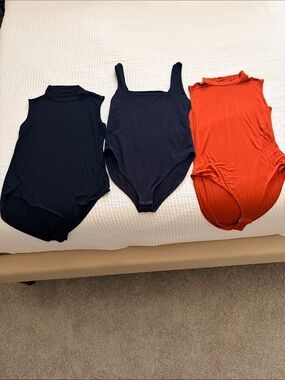 Three bodysuits- two mock neck, one square neck